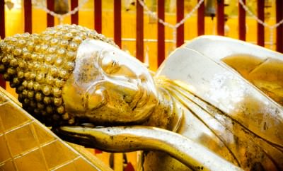 Reclining buddha statue at Doi Suthep Temple in Chiang Mai, Thailand.
