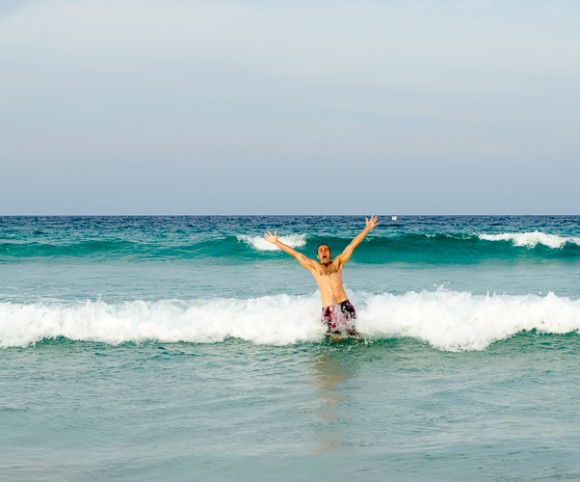 Adrian playing in the waves of Perhentian Kecil, Malaysia