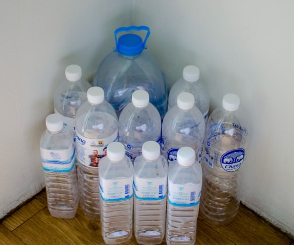 A collection of water bottles in the corner of our guesthouse room.